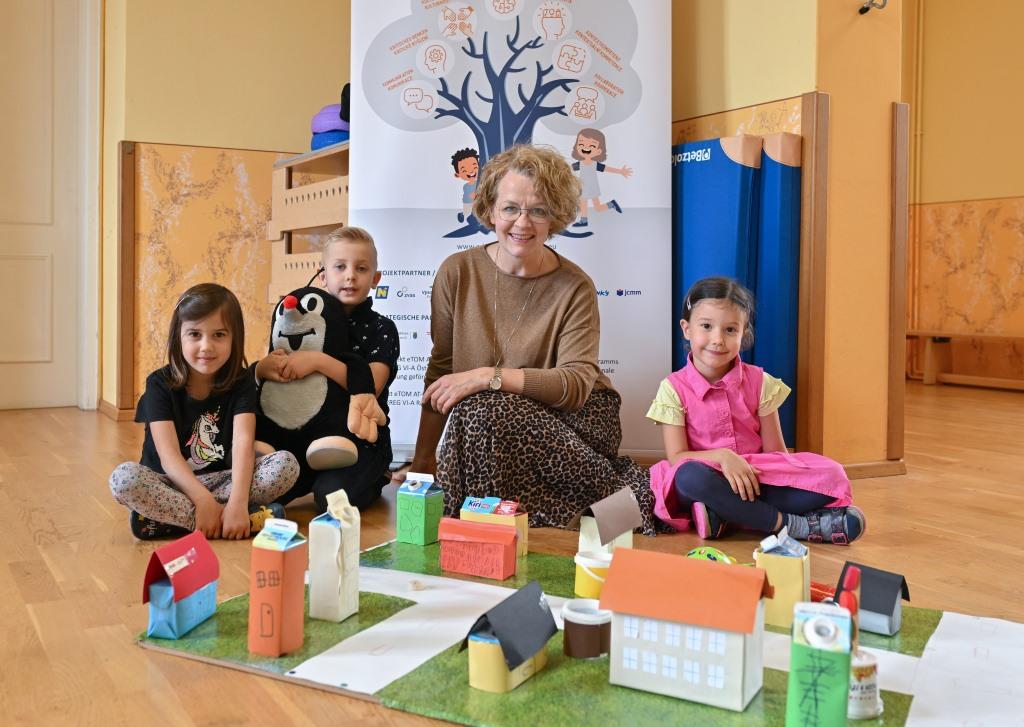 (v.l.n.r.): Familien-Landesrätin Christiane Teschl-Hofmeister (3.v.l.) mit Ronja, Daniel, und Anna, die in ihrem Kindergarten an einem der grenzüberschreitenden Projekte teilnehmen